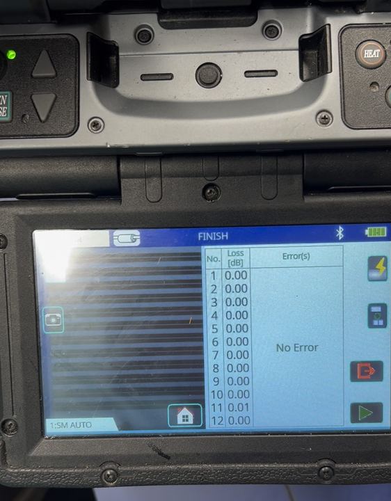 Fusion splicer screen showing 12-fiber ribbon splice losses of 0.00 dB with No Error