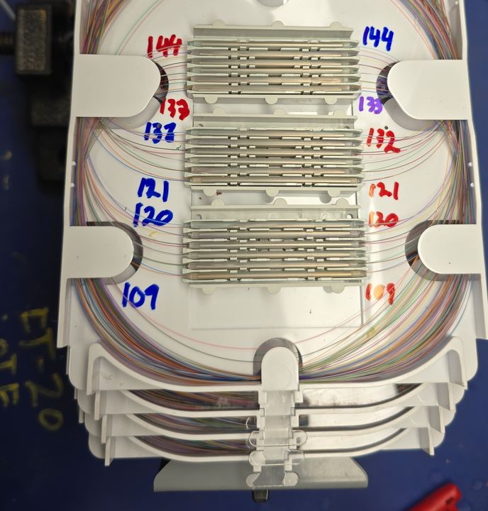 Splice tray with fiber ranges labeled 109 through 144