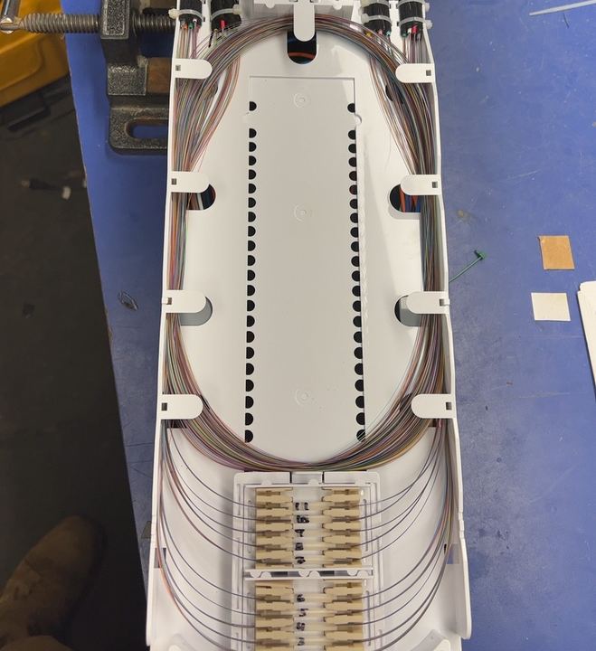 Clean splice tray with organized fiber loops and a bank of LC connectors